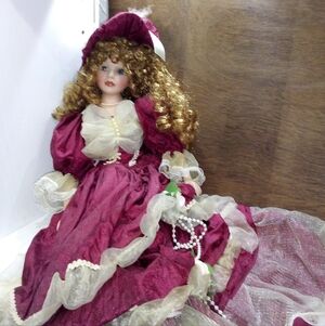 Elegant Burgundy Porcelain Doll
